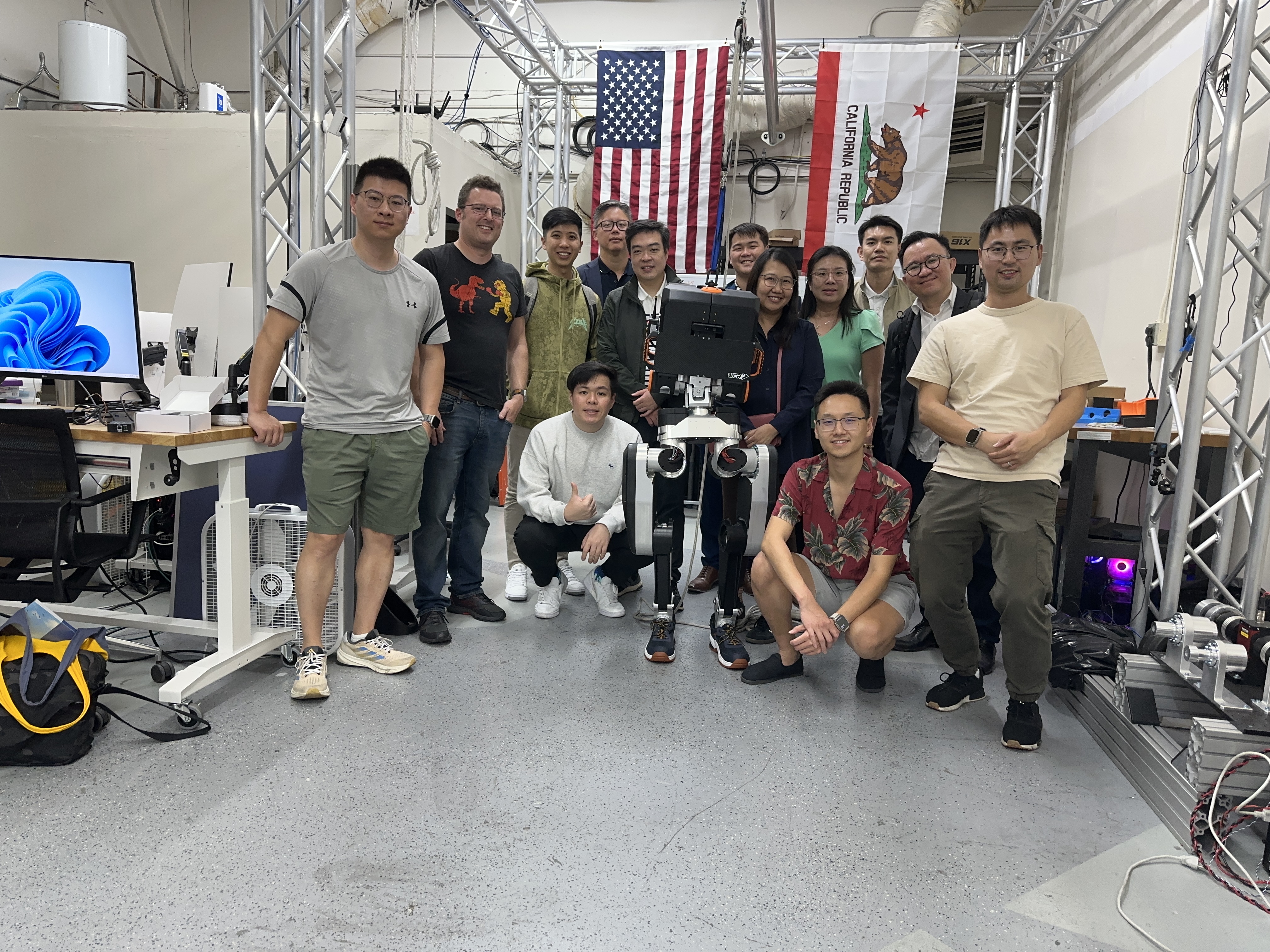 UCR team and visitors with humanoid robot in lab